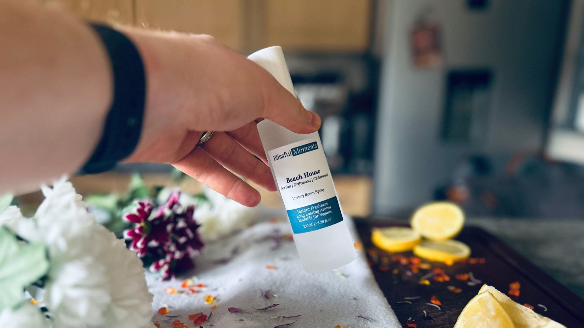 Someone grabbing a Beach House scented luxury room spray