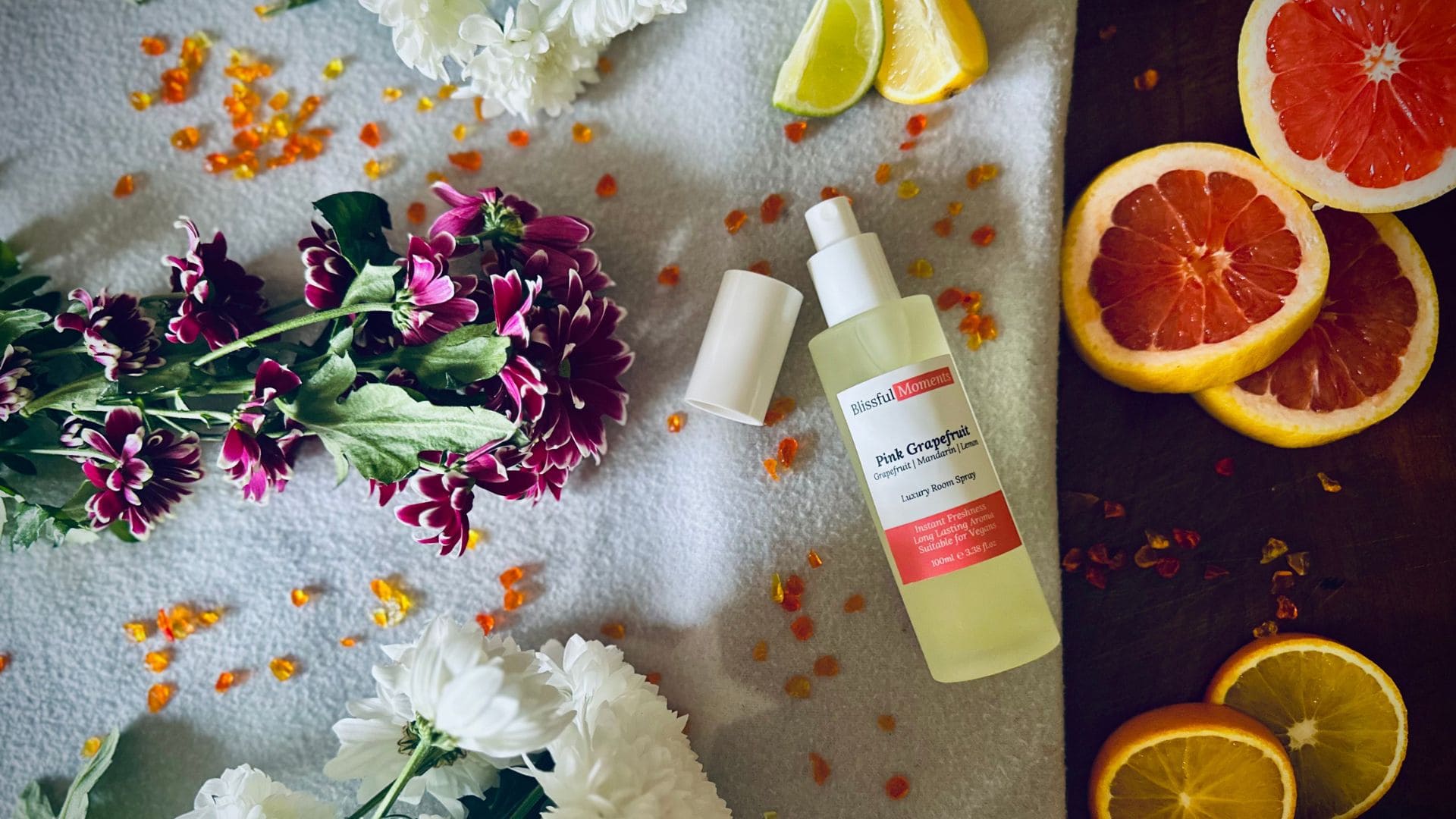 Luxury Pink Grapefruit Room Spray surrounded by citrus fruits