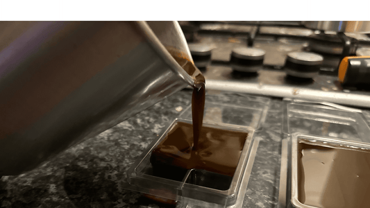 wax being poured into 6 cubed clamshells