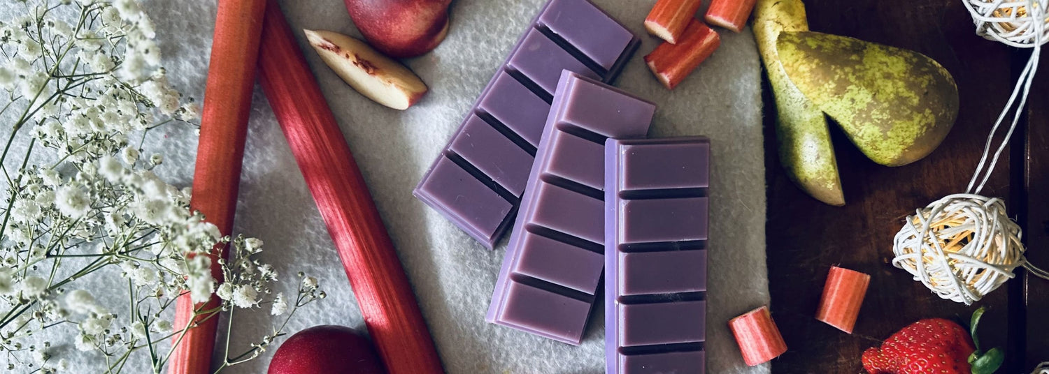 Fruity Wax Melts - Purple black plumb and Rhubarb wax melts on a soft cotton blanket