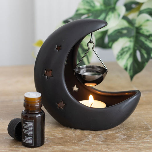 Black moon wax melt and oil burner in a home office setting