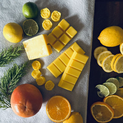 Lemon scented soy wax melts surrounded by citrus fruits