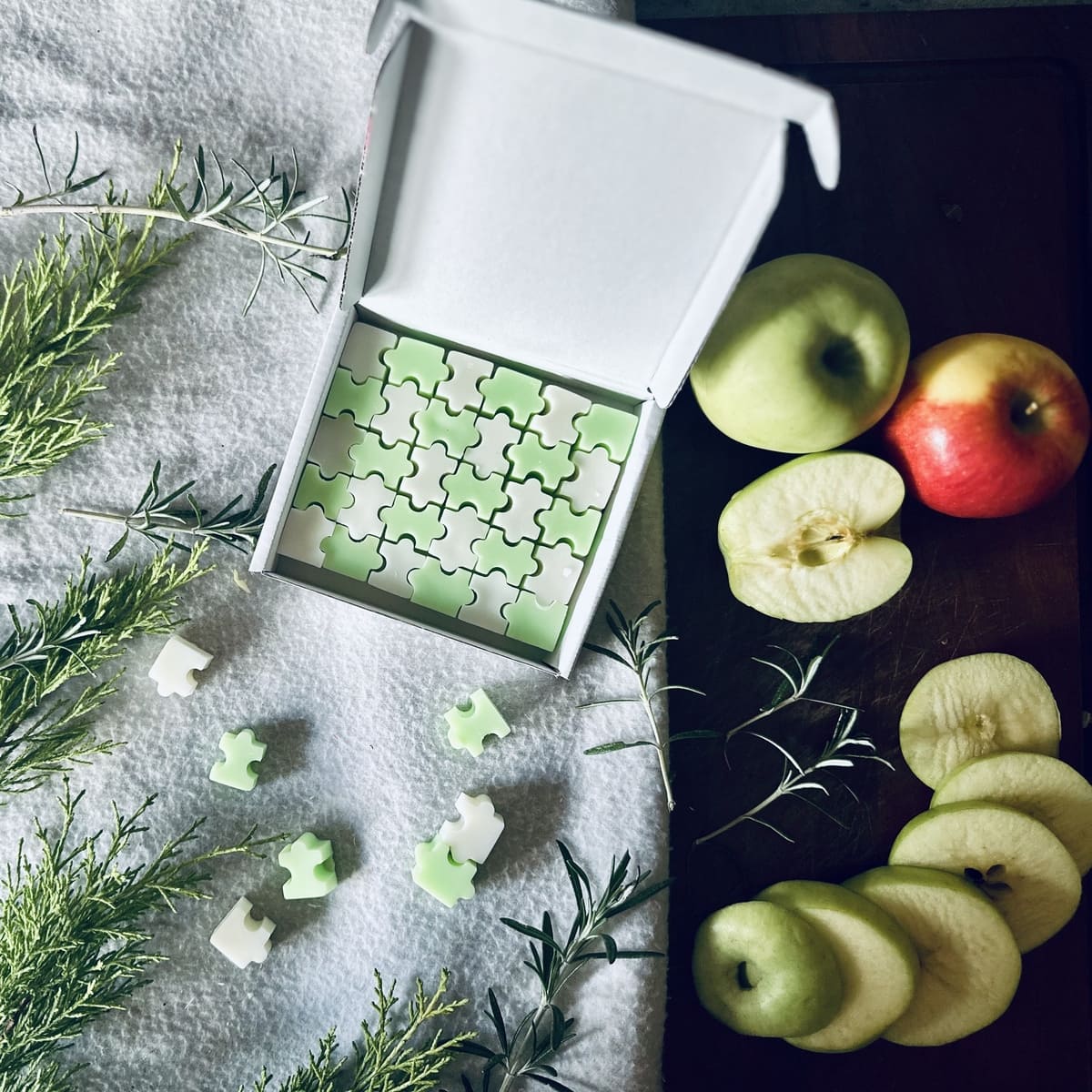 fruity apple scented puzzle shaped soy wax melts surrounded by green and red apples