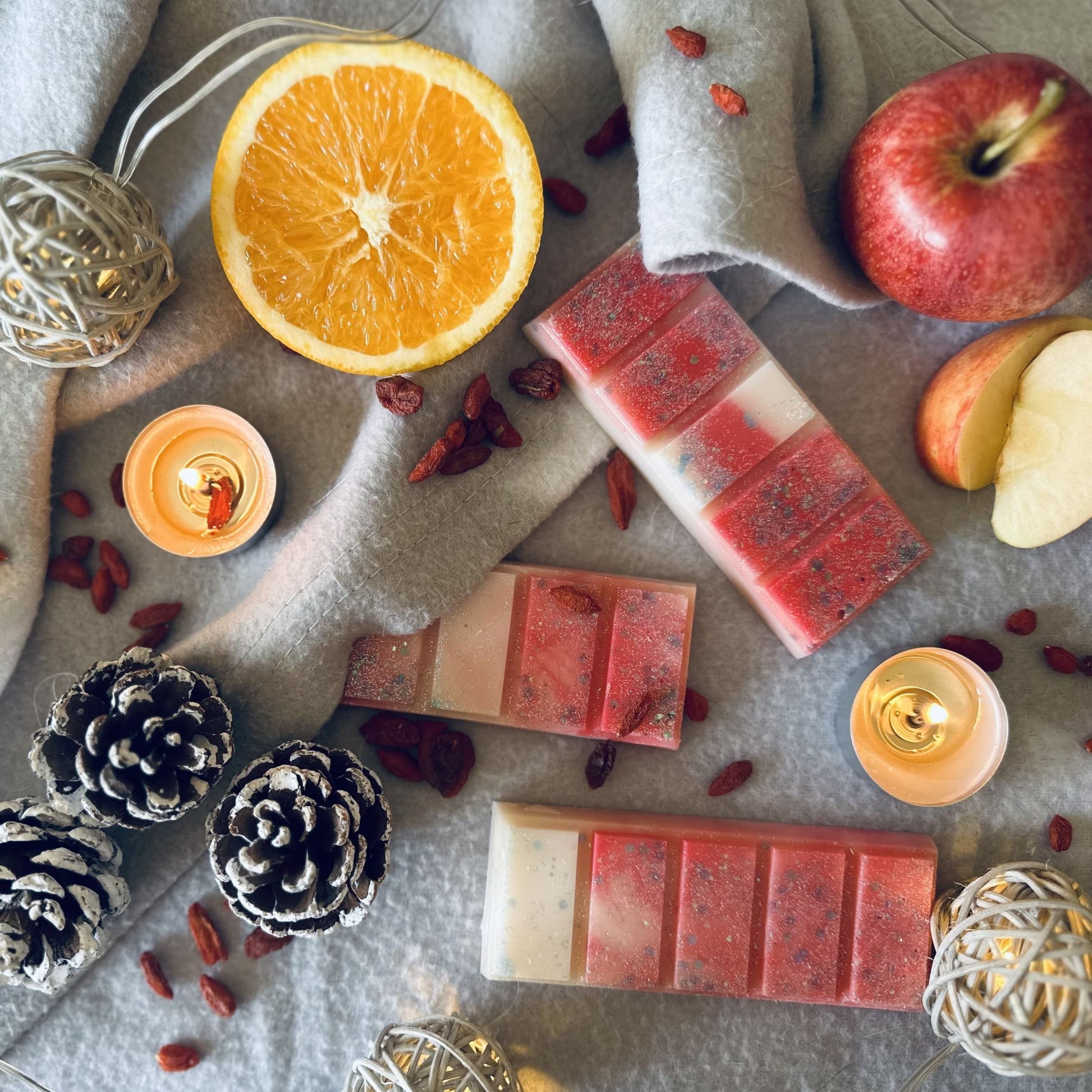 Fruity winter berries scented soy wax melts surrounded by Christmas winter berries, red apples and cosy Christmas lights