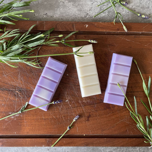 Purple and white soy wax melts surrounded by fresh lavender