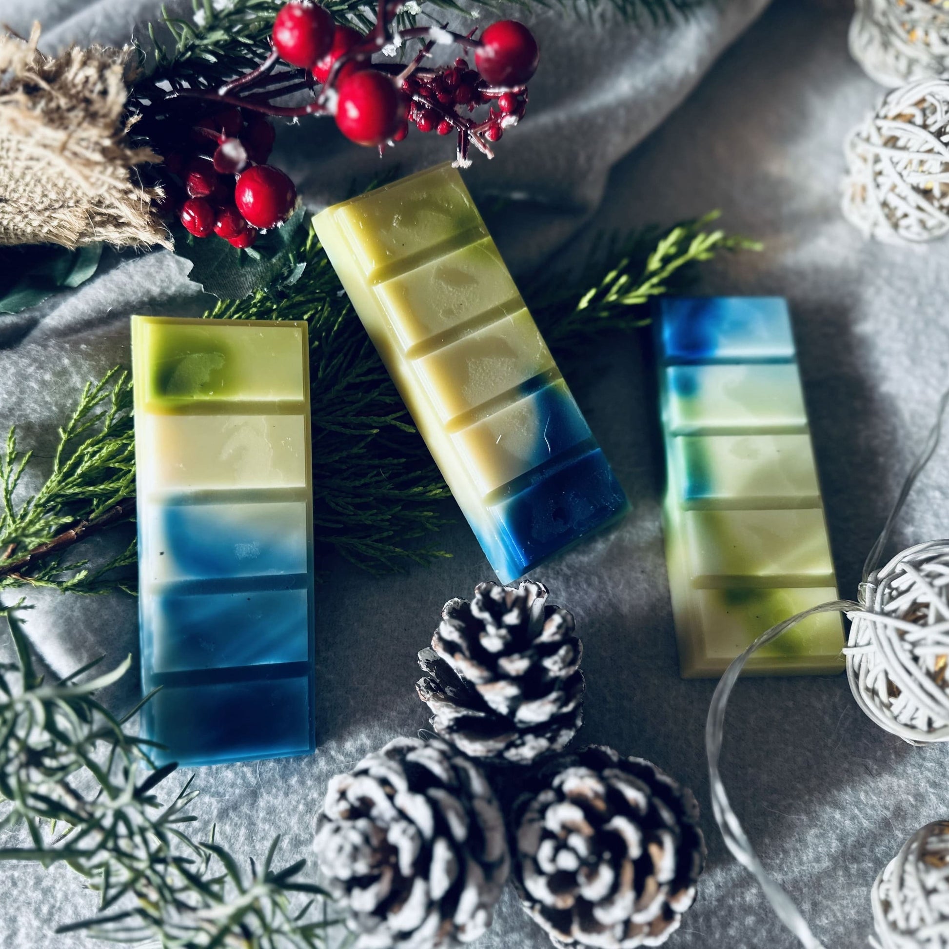 white, green and blue soy wax melts in a Christmas winter wonderland setting surrounded by fairy lights