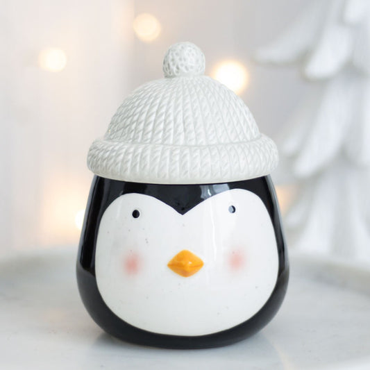 Penguin designed wax melt and oiler burner with a wooly styled lid in a winter wonderland setting