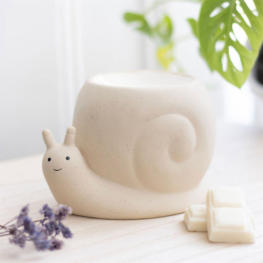 Snail designed wax melt and oil burner on a wooden table top