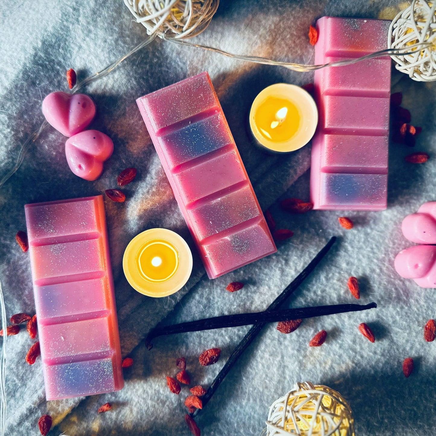 Pink snow fairy soy wax melts in a cosy and relaxing setting surrounded by tealights and fairy lights