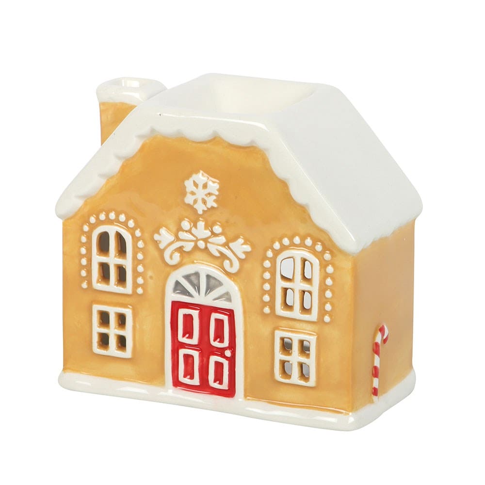 Gingerbread house shaped wax melt burner with a red door on a white background