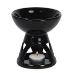 Black ceramic oil burner with a lit tealight candle on a white background