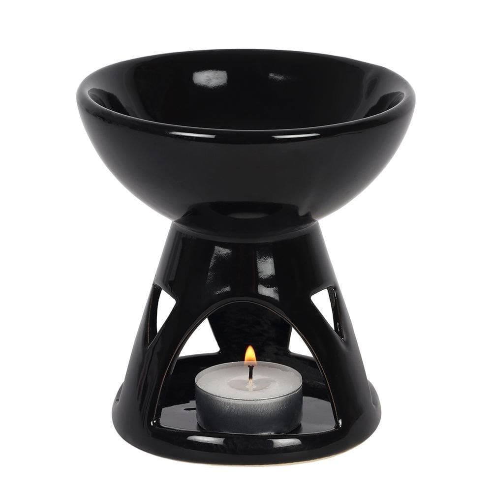 Black ceramic oil burner with a lit tealight candle on a white background