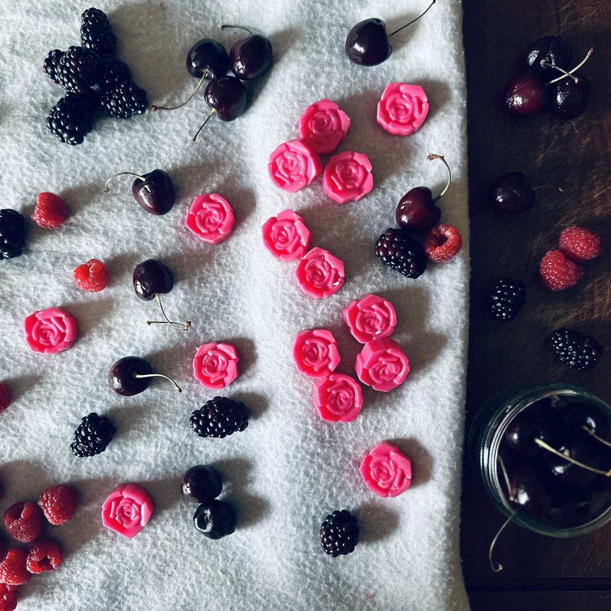 Black Cherry scented Soy Wax Melts shaped as a flower surrounded by cherries