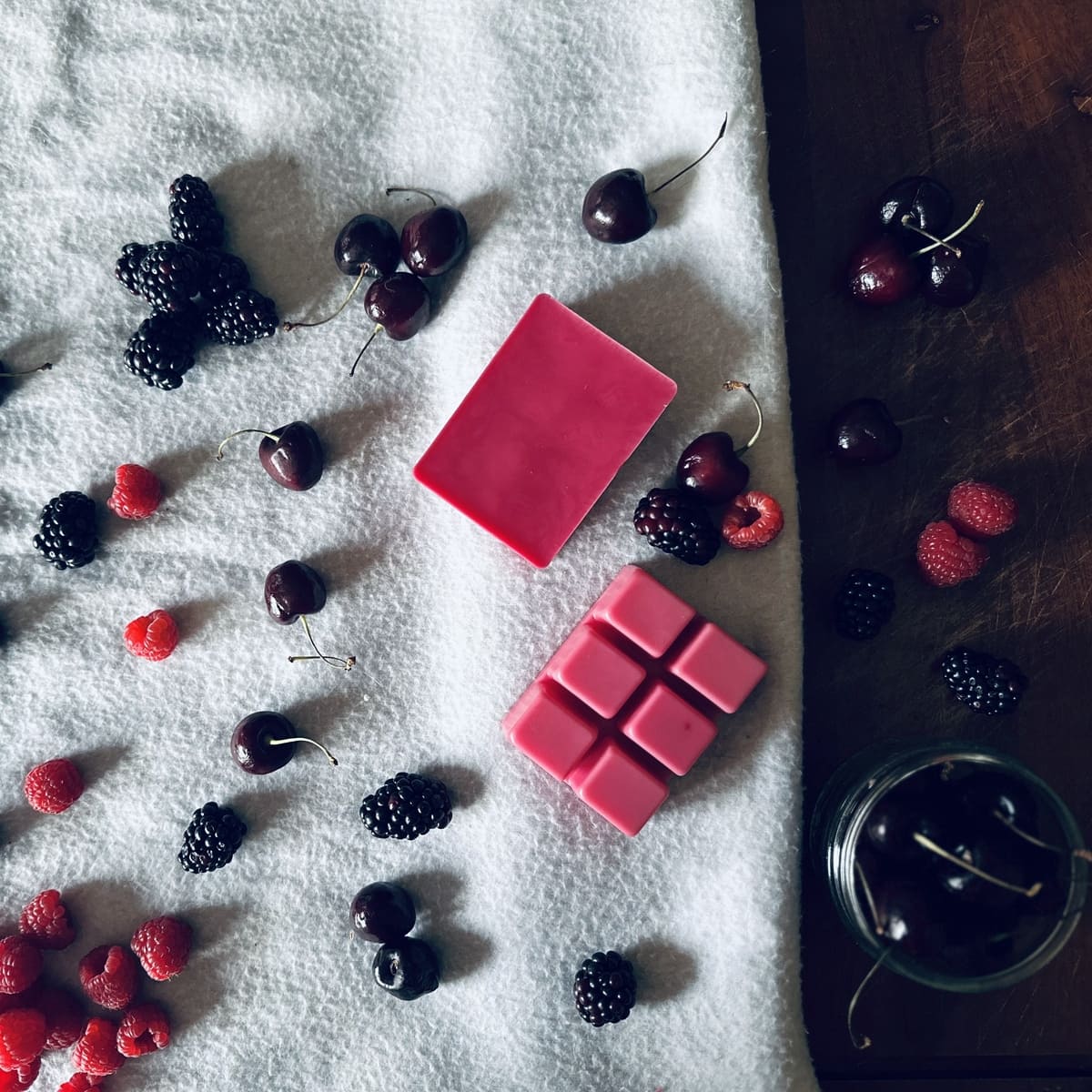 Black Cherry scented Soy Wax Melts clamshell surrounded by cherries