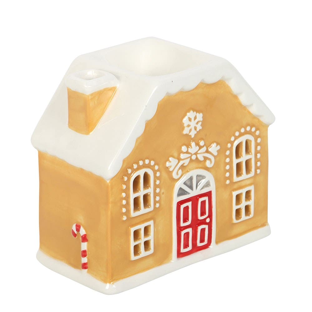 Gingerbread house shaped wax melt burner with a red door on a white background
