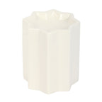 White ceramic star shaped wax melt burner on a white background.