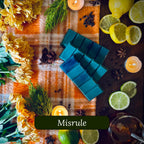 Green wax melts on a decorative surface with flowers, candles, and fruits.