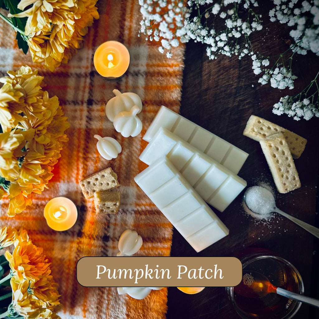 White Pumpkin snapbar wax melts surrounded by flowers and candles on a orange blanket