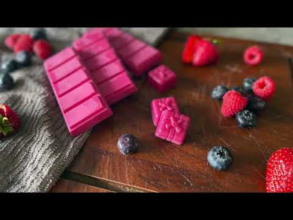 Autumn Berry highly scented soy snpabar wax melts, red coloured on a wooden board surrounded by autumn berries and fairy lights